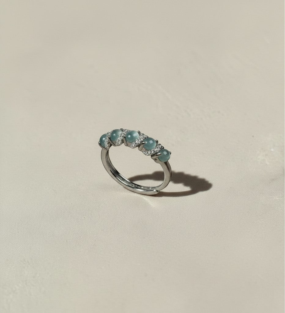 Findingyoyo adjustable sterling silver ring featuring blue Guatemalan jadeite cabochons and sparkling zircon accents.