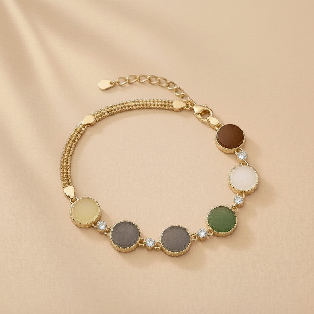 Findingyoyo Full Fortune bracelet featuring five-tone Hetian jade beads and gold vermeil accents on a beige background.