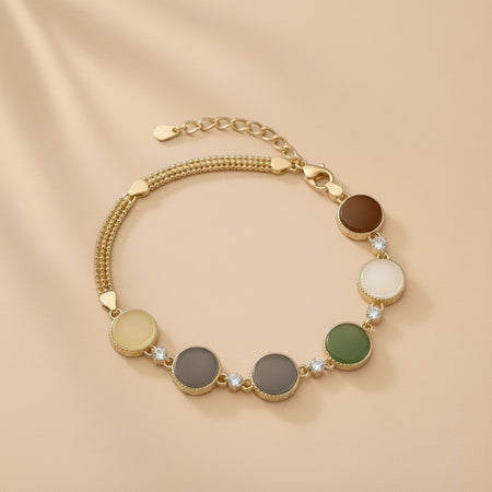 Findingyoyo Full Fortune bracelet featuring five-tone Hetian jade beads and gold vermeil accents on a beige background.
