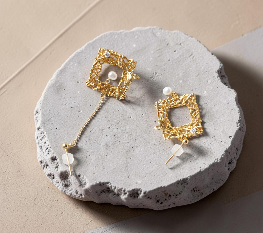 Findingyoyo Chirping Window earrings featuring gold-filled square frames with freshwater pearls on white fabric.
