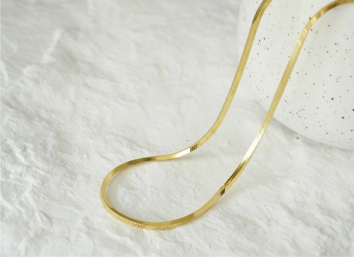 Findingyoyo Sardina gold vermeil herringbone chain necklace with a smooth, flat, interlocking link design.
