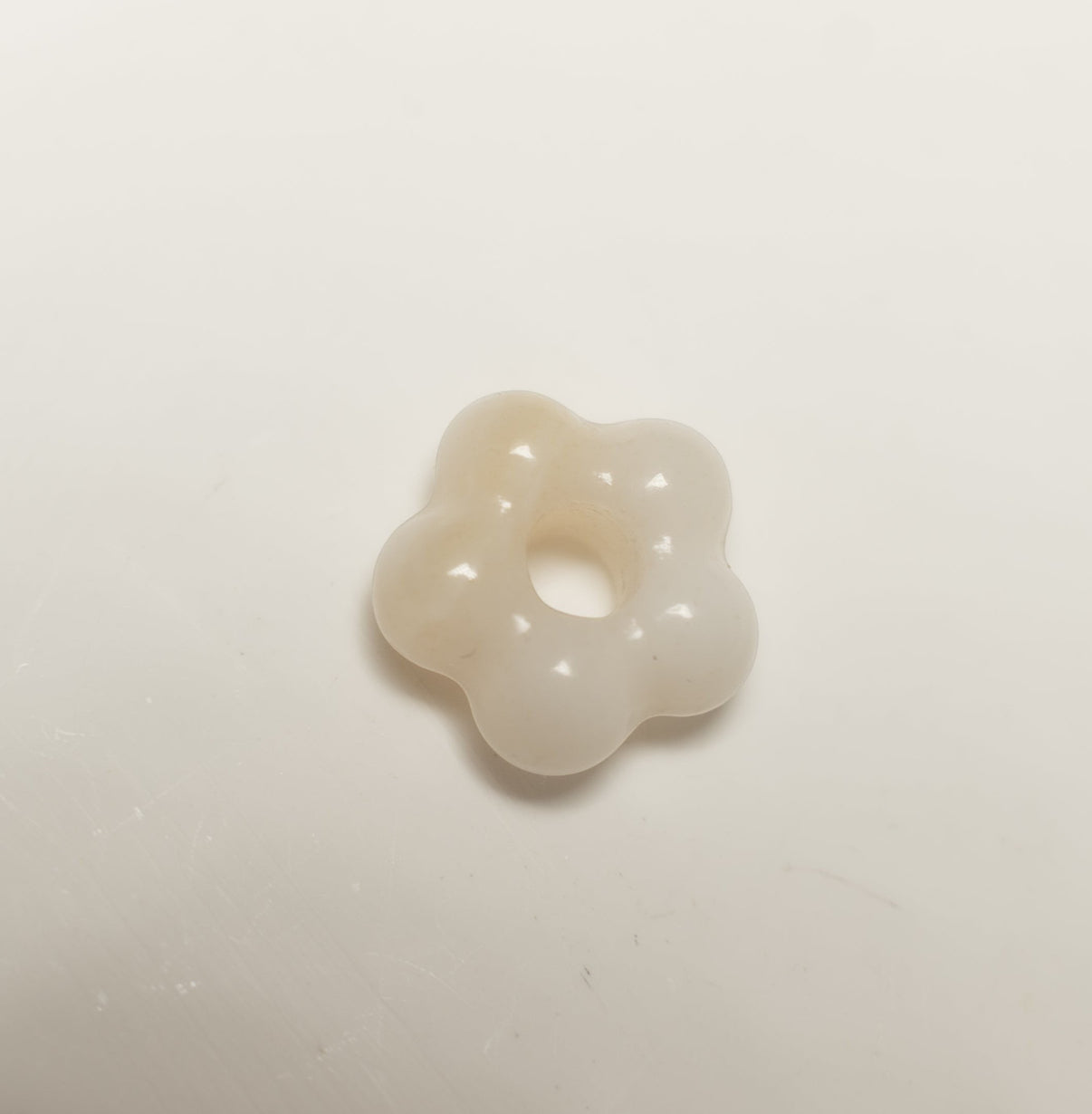 Findingyoyo hand-carved ivory Hetian jade flower pendant with a smooth, organic petal shape.