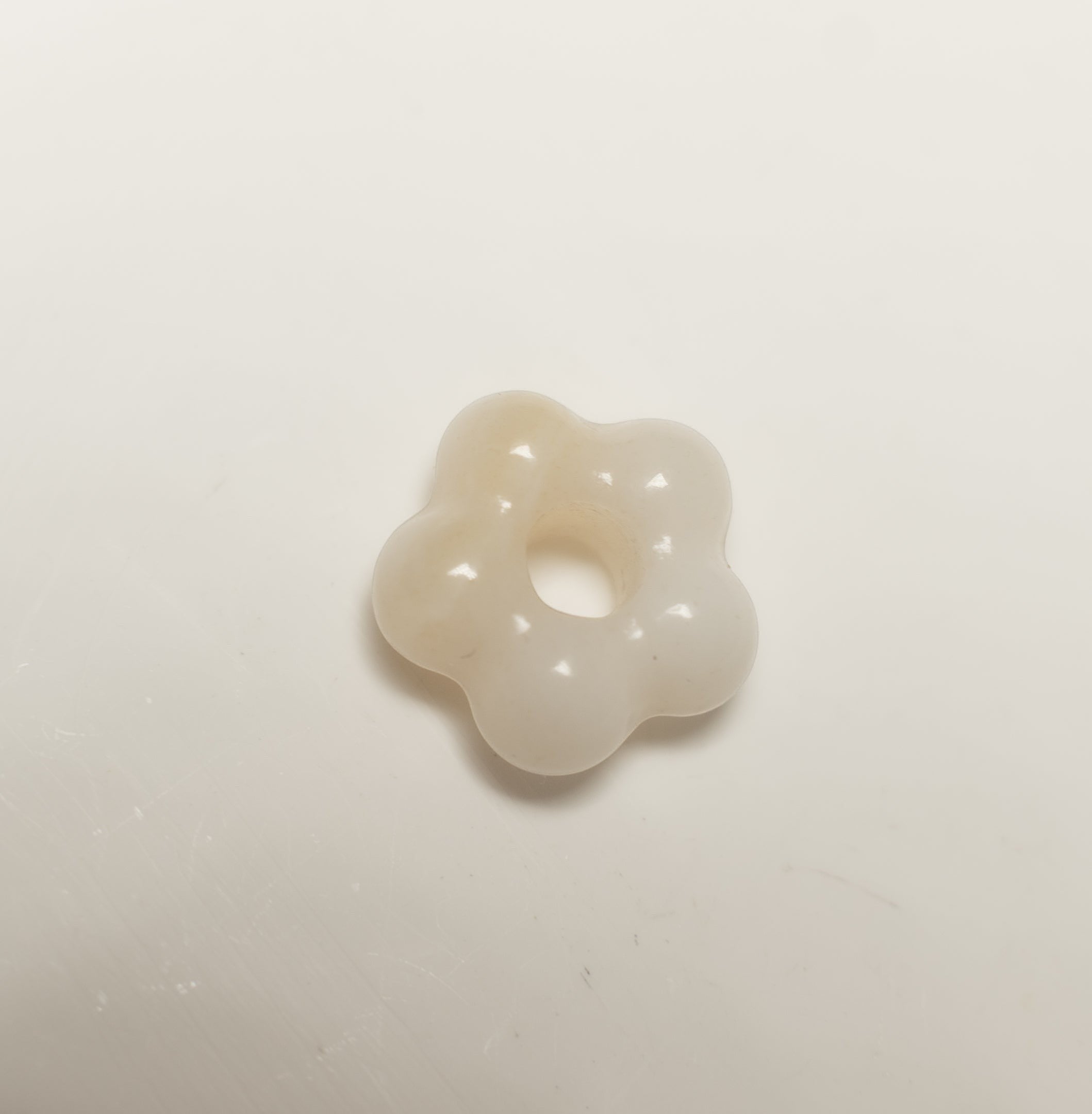 Findingyoyo hand-carved ivory Hetian jade flower pendant with a smooth, organic petal shape.