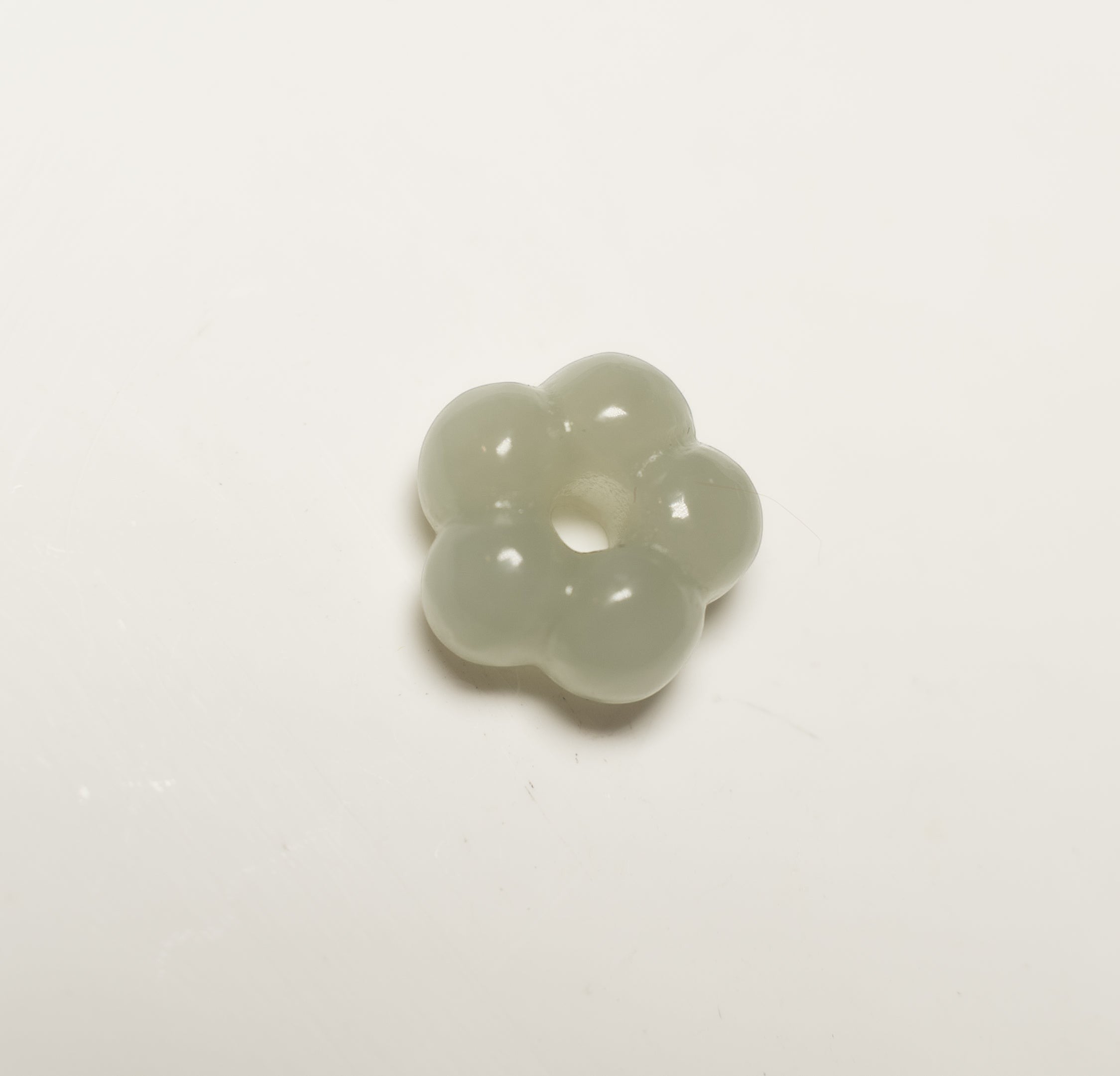 Findingyoyo Jardin necklace pendant featuring a hand-carved pale celadon Hetian jade flower with a central clasp ring