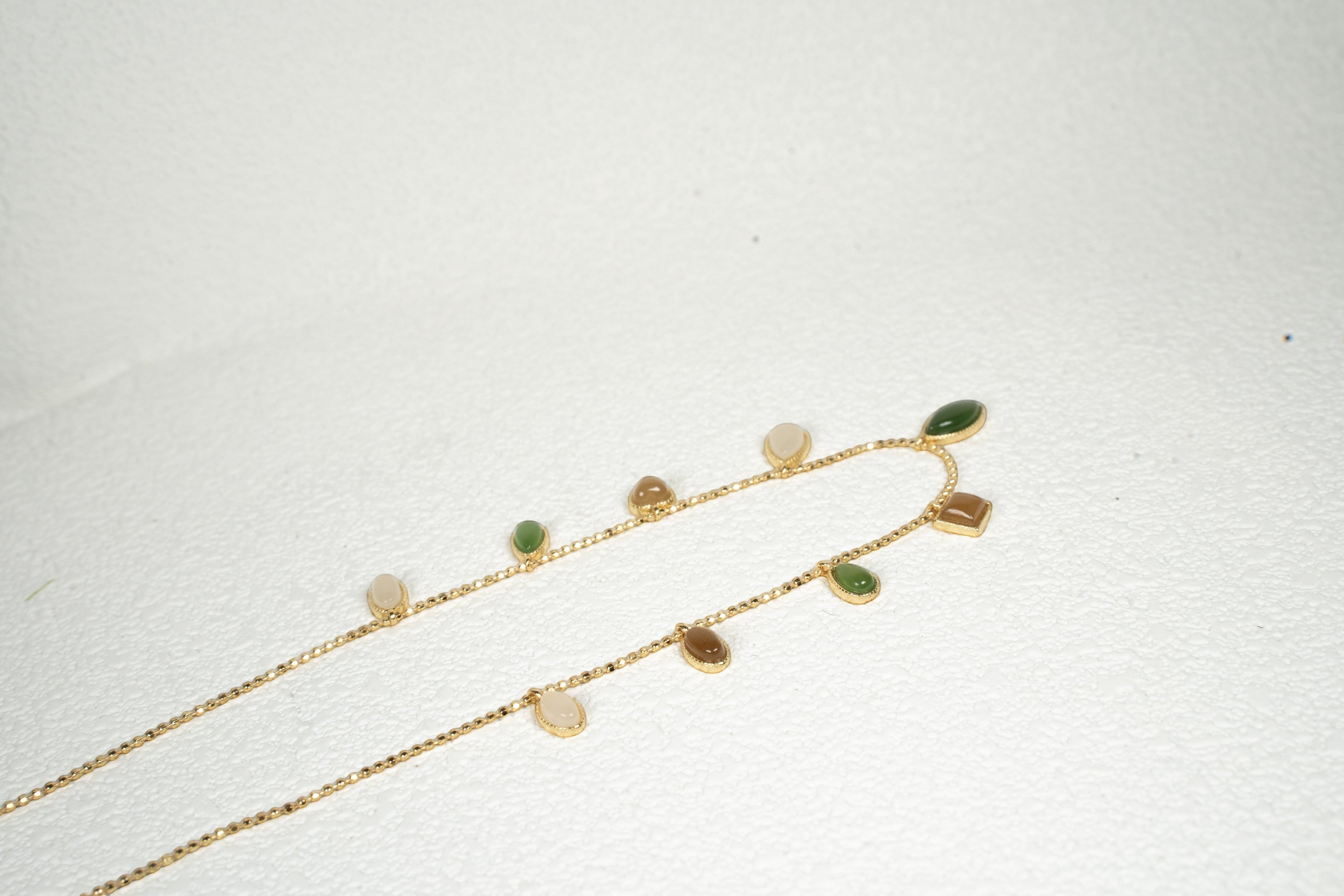 Findingyoyo Full Fortune necklace featuring multi-colored Hetian jade charms on a delicate gold vermeil chain.