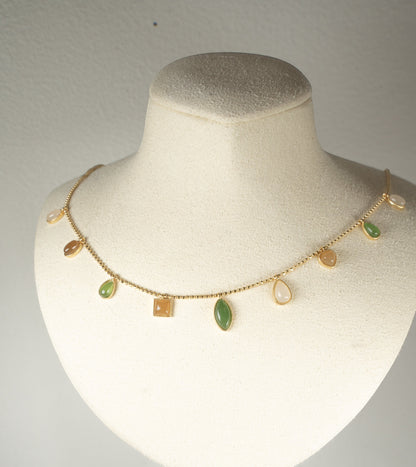 Findingyoyo necklace featuring multi-shaped Hetian jade stones in five elemental tones with gold vermeil accents.