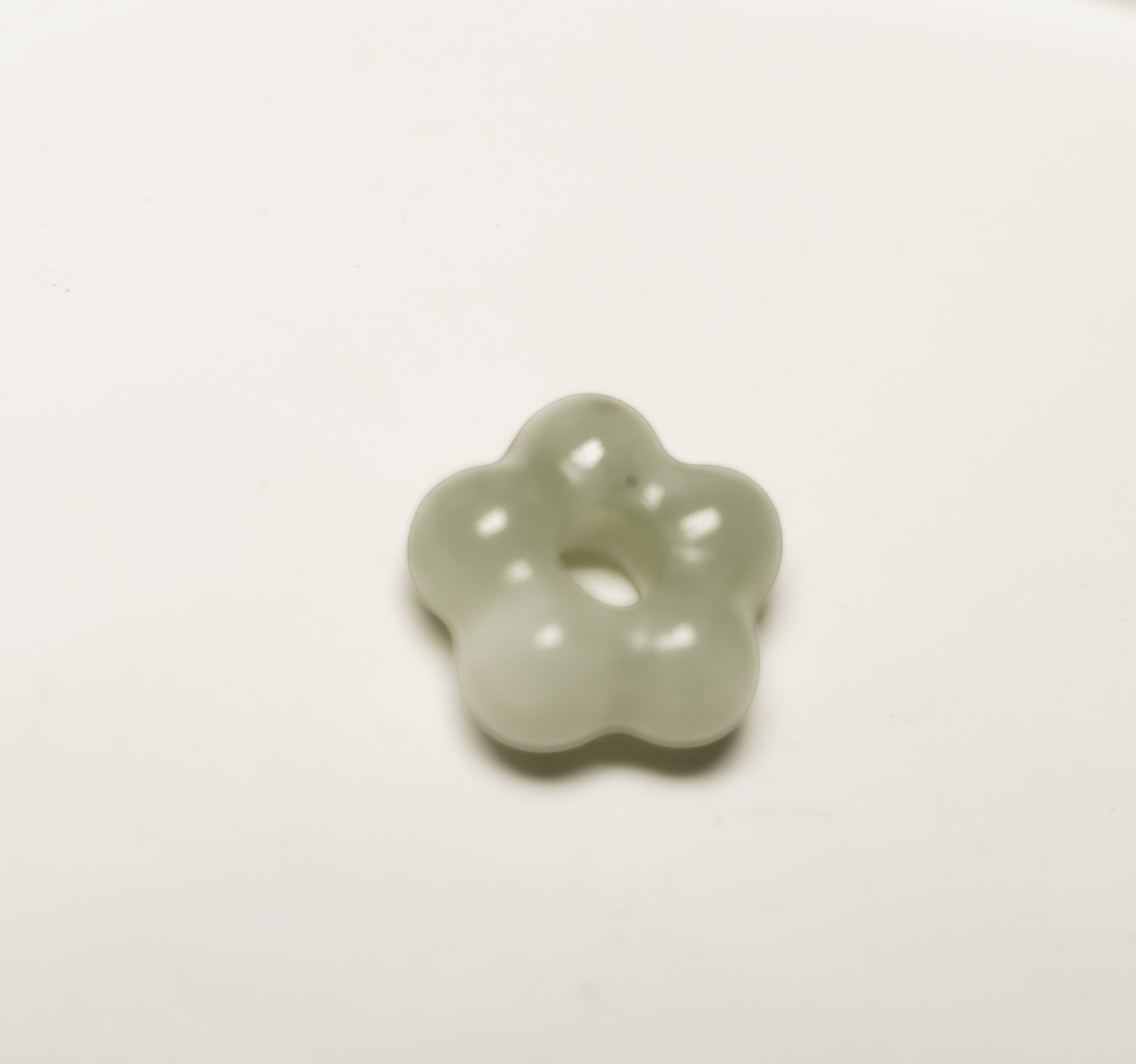 Findingyoyo Jardin Necklace featuring a hand-carved pale celadon Hetian jade flower pendant with a smooth finish.