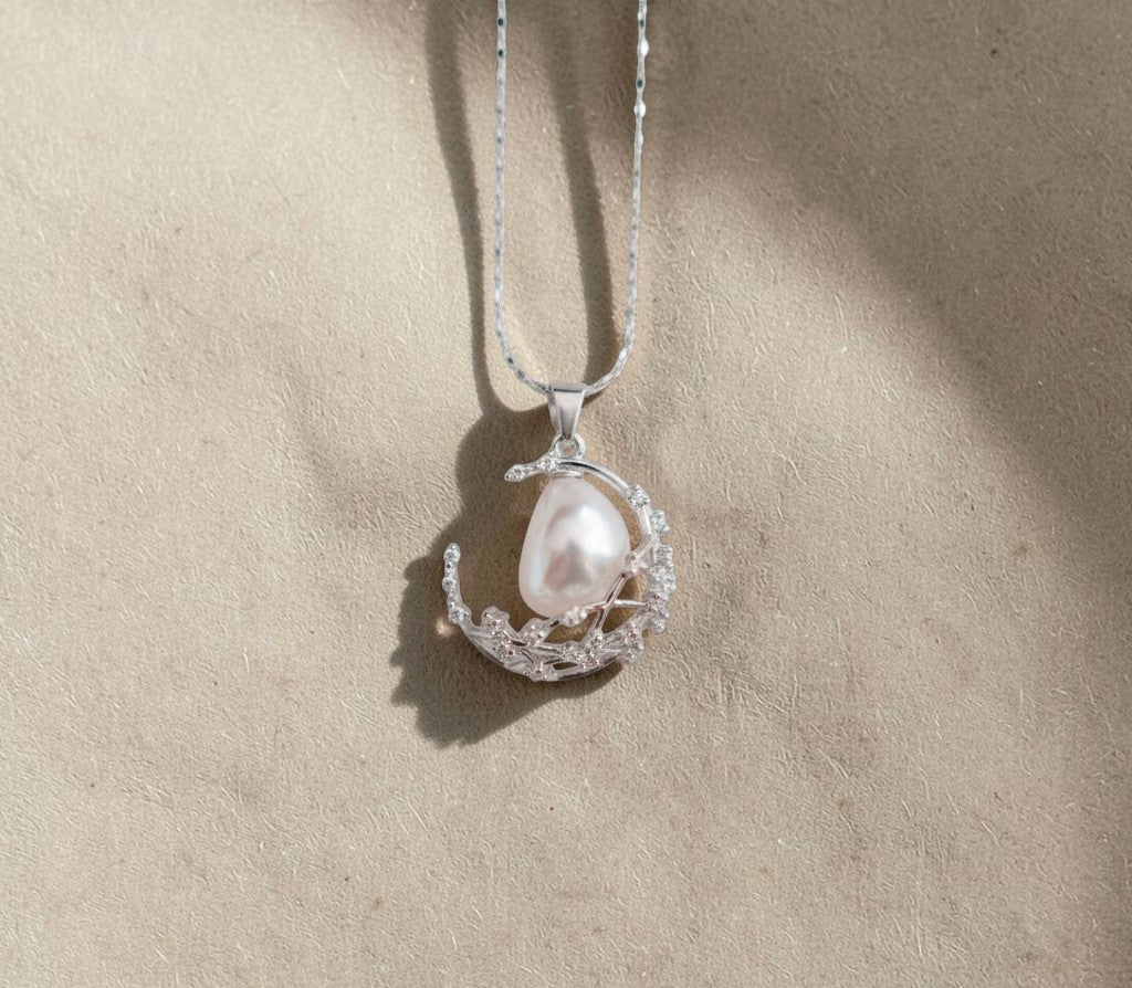 Findingyoyo moon and stars pendant necklace featuring a baroque freshwater pearl set in 18K white gold plated silver.