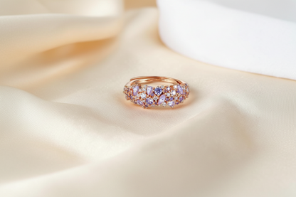 Findingyoyo Olivetta ring in 18K rose gold plated sterling silver with moissanite stones on a champagne silk fabric.