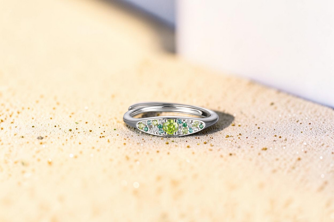 Findingyoyo Reverie ring in sterling silver with rhodium featuring a cluster of green and clear moissanite stones.