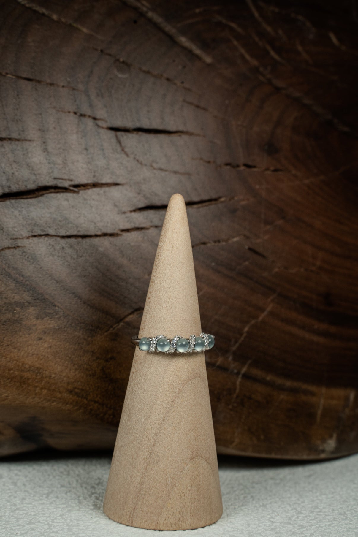 Findingyoyo adjustable ring featuring blue Guatemalan jadeite stones and zircon accents set in rhodium-plated silver.