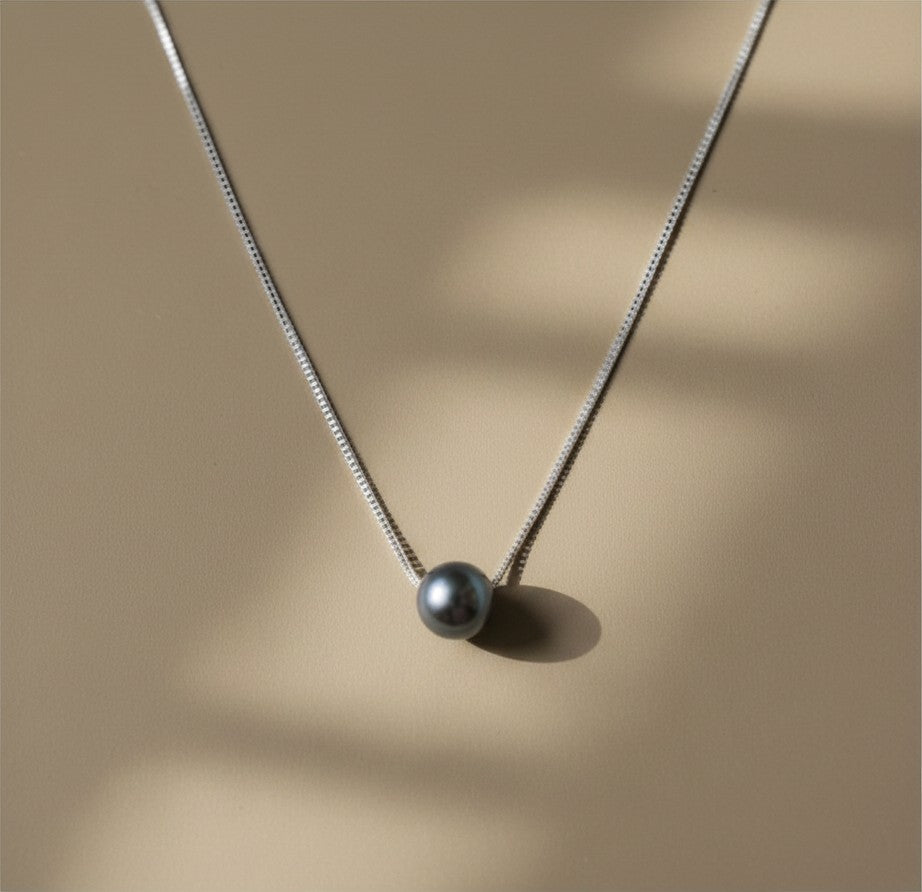 Findingyoyo Calypso necklace featuring a single Tahitian black pearl on a delicate sterling silver chain.