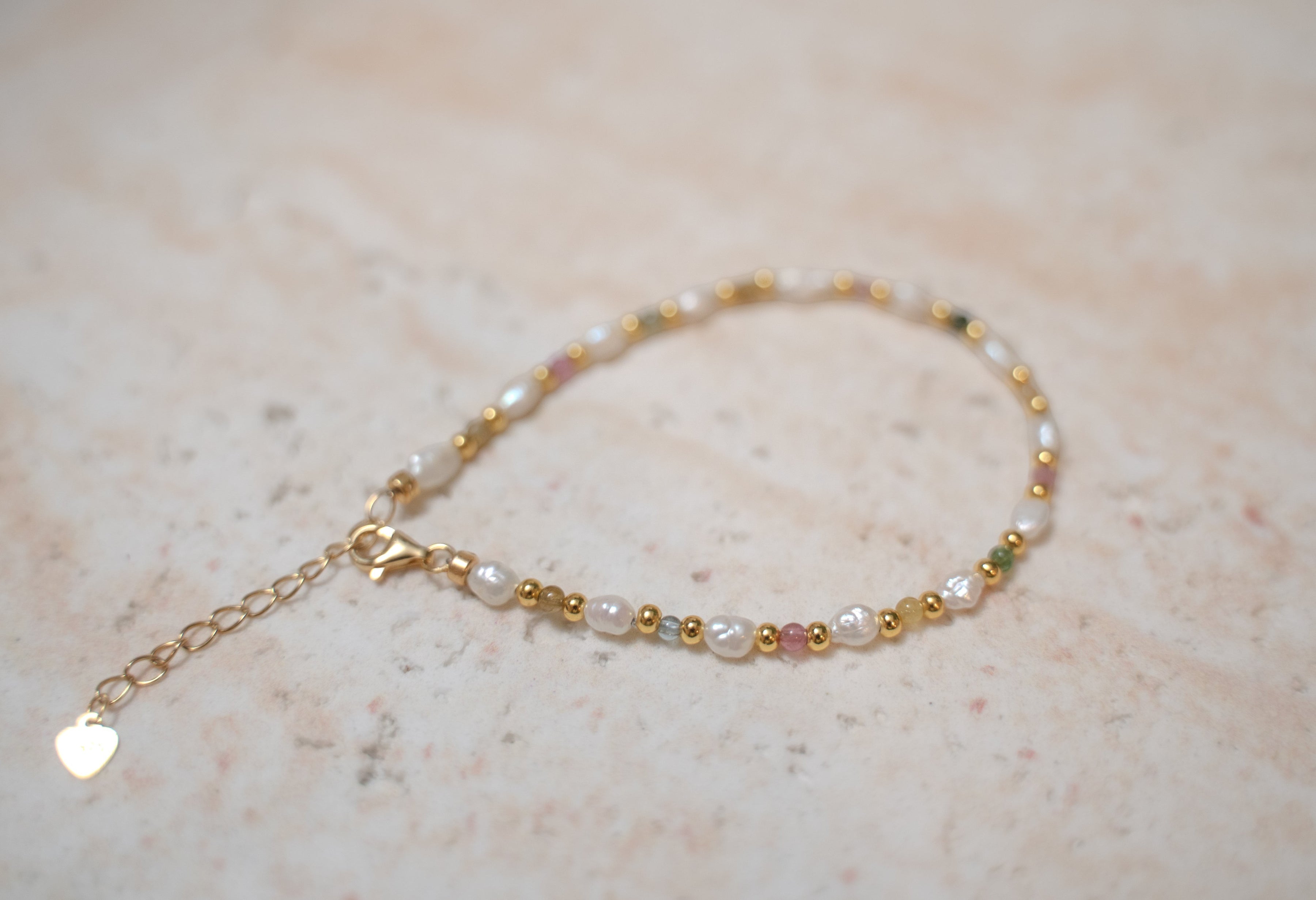 Findingyoyo Skittles bracelet featuring natural tourmaline stones and freshwater keshi pearls on gold vermeil chain.