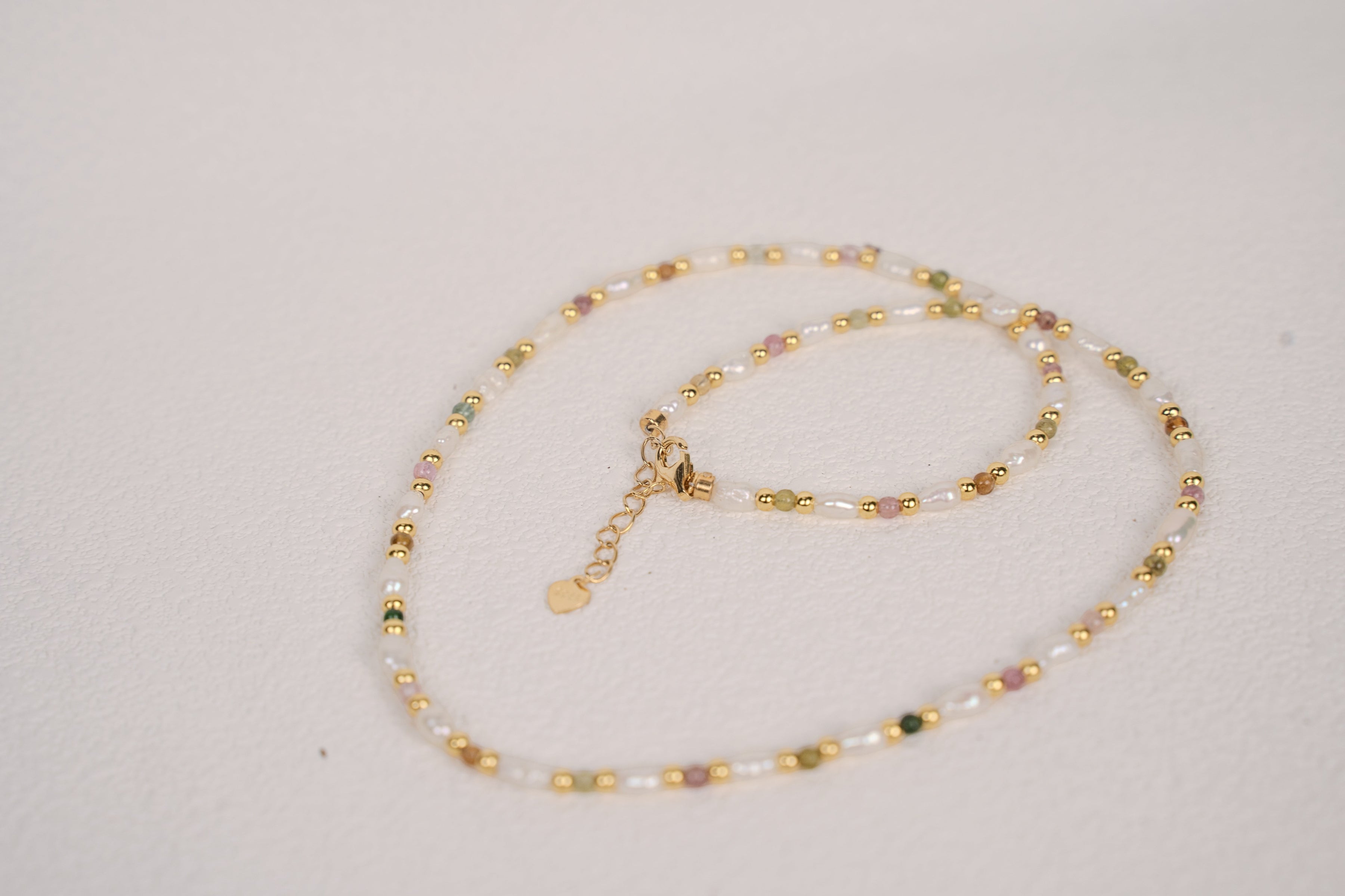 Findingyoyo Skittles necklace featuring multicolored natural tourmaline stones and freshwater keshi pearls in gold vermeil