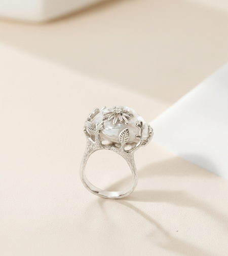 Findingyoyo Winter Jasmine ring featuring a white baroque freshwater pearl set in a rhodium-plated silver floral band.