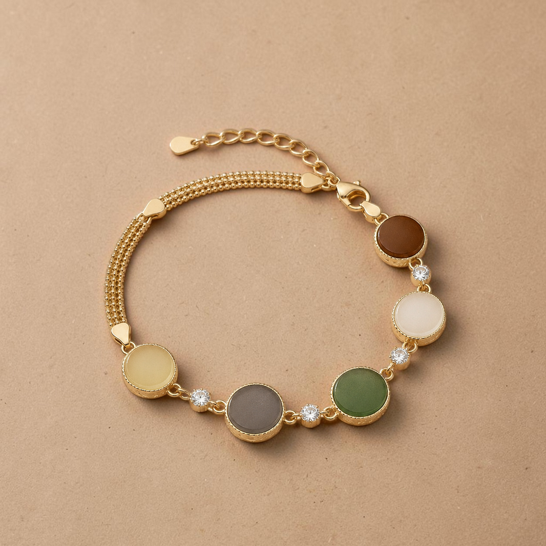 Findingyoyo Full Fortune bracelet featuring five-toned Hetian jade beads and gold vermeil accents on a beige background